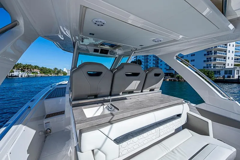 Slide: The Image of 2023 Tiara Sport 34 LS luxury boat interior with sleek seating and modern design. - 38