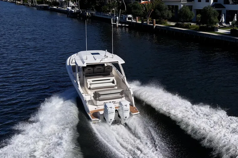 Slide: The Image of 2023 Tiara Sport 34 LS cruising on a scenic waterway. - 4