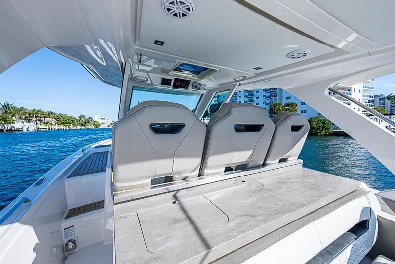 Slide: The Image of 2023 Tiara Sport 34 LS luxury boat interior with sleek seating and waterfront view. - 47