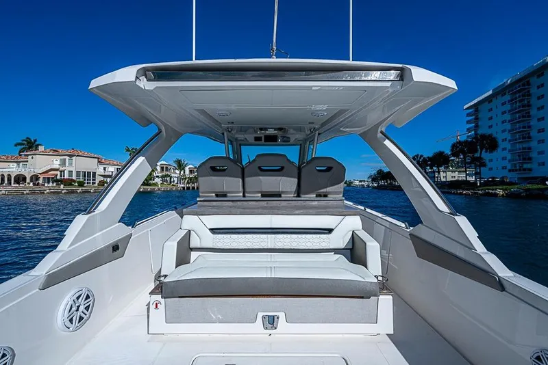 Slide: The Image of 2023 Tiara Sport 34 LS luxury boat interior with seating, under clear blue sky. - 48