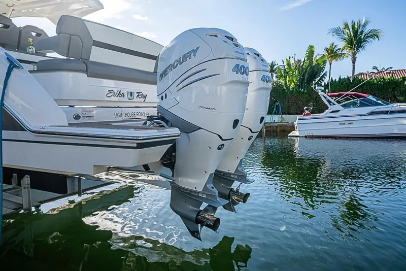 Slide: The Image of 2023 Tiara Sport 34 LS with twin Mercury 400 engines docked in a sunny marina. - 50