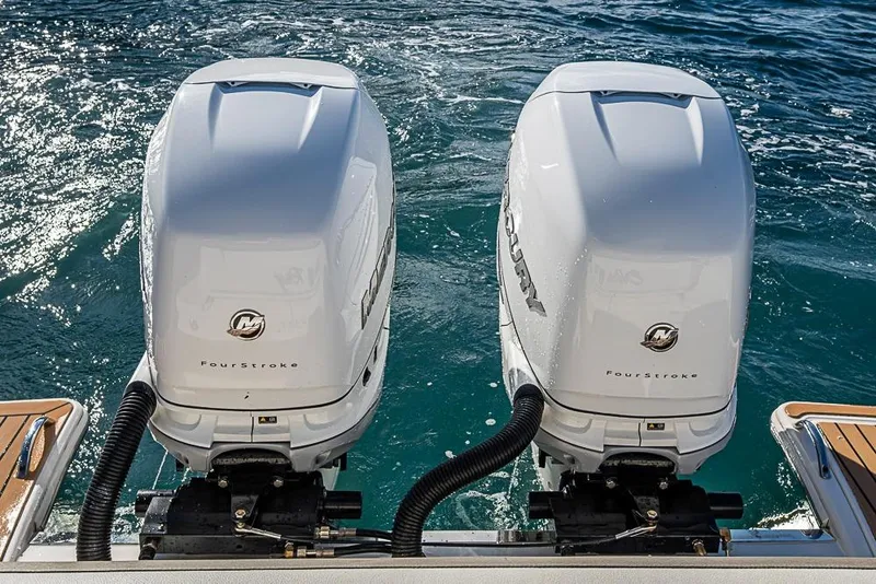 Slide: The Image of Twin Mercury FourStroke engines on 2023 Tiara Sport 34 LS boat, ocean backdrop. - 52