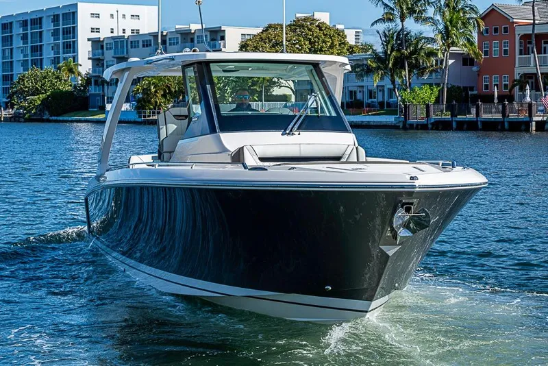 Slide: The Image of 2023 Tiara Sport 34 LS boat cruising on a sunny waterfront. - 54
