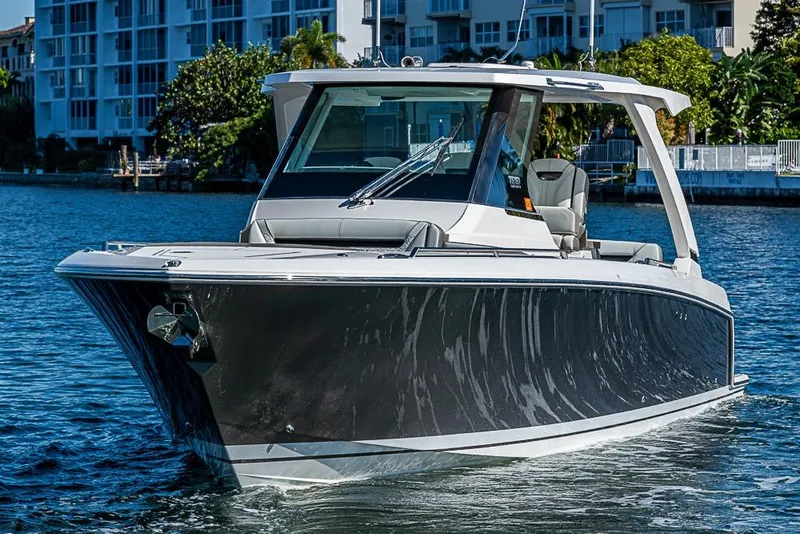 Slide: The Image of 2023 Tiara Sport 34 LS boat cruising on a sunny waterfront. - 56