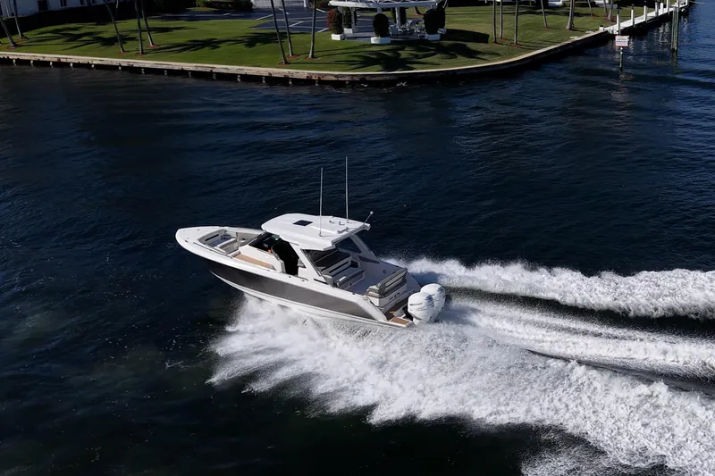Slide: The Image of 2023 Tiara Sport 34 LS boat cruising on a scenic waterway. - 7