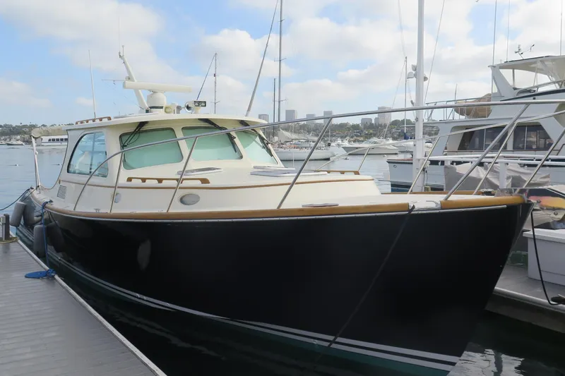 The Image of 2007 Hinckley Talaria 40 yacht docked at marina under cloudy sky. - 0