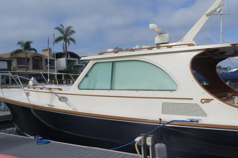 Slide: The Image of 2007 Hinckley Talaria 40 yacht docked, featuring sleek design and elegant wood accents. - 14
