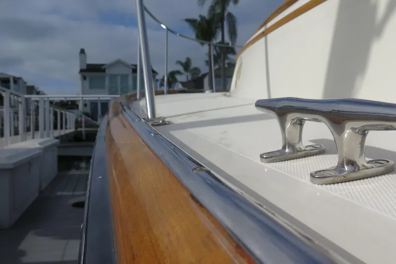 Slide: The Image of 2007 Hinckley Talaria 40 yacht deck with polished cleat and wooden railing. - 15