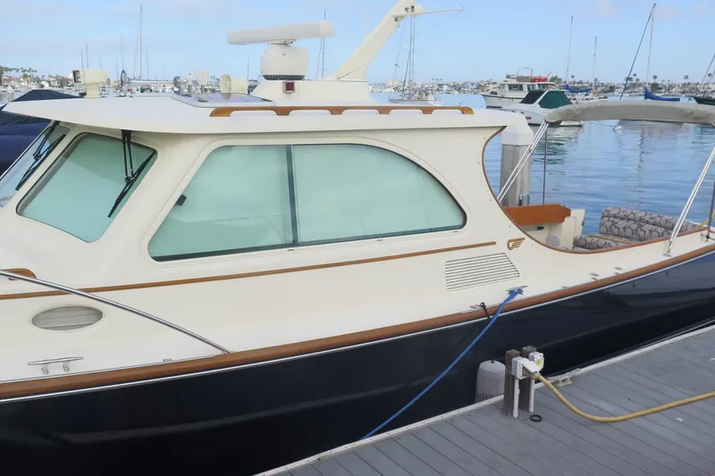 Slide: The Image of 2007 Hinckley Talaria 40 yacht docked at marina, showcasing elegant design and craftsmanship. - 16