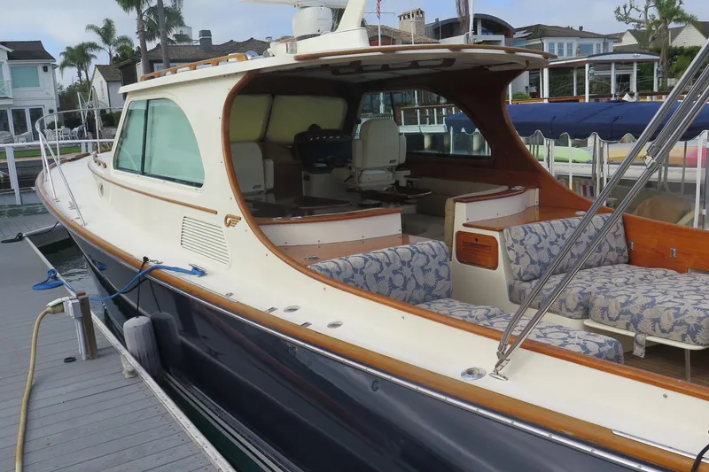 Slide: The Image of 2007 Hinckley Talaria 40 yacht docked, featuring elegant seating and classic design. - 17