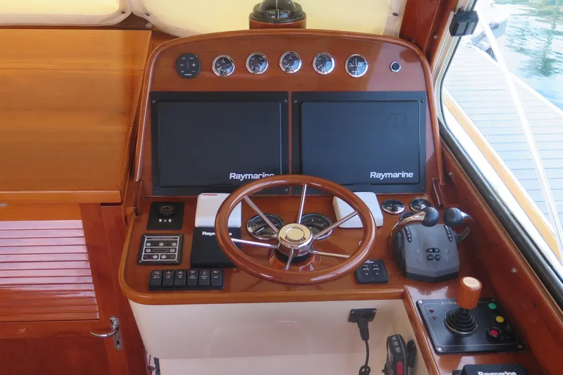 Slide: The Image of Helm of 2007 Hinckley Talaria 40 with Raymarine navigation system and wooden steering wheel. - 18