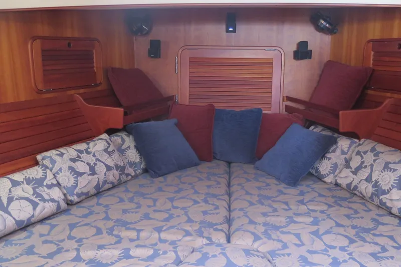 Slide: The Image of Interior of 2007 Hinckley Talaria 40 with floral cushions and wooden accents. - 19