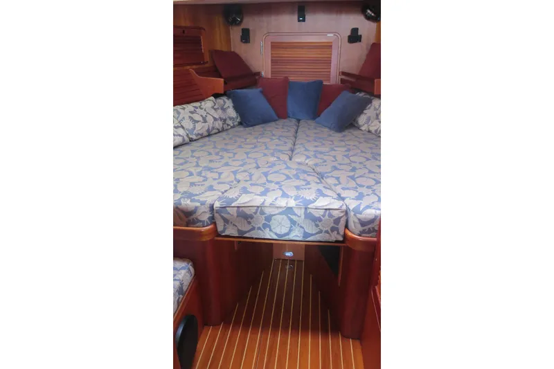 Slide: The Image of Interior cabin of 2007 Hinckley Talaria 40 with patterned bedding and wooden accents. - 20
