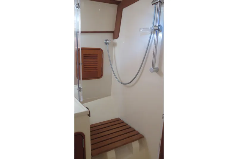 Slide: The Image of Shower area in 2007 Hinckley Talaria 40 yacht with wooden seat and handheld showerhead. - 27