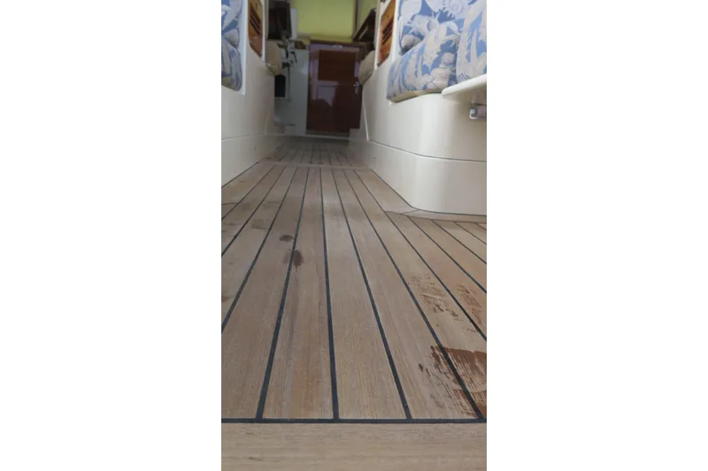 Slide: The Image of Teak flooring inside a 2007 Hinckley Talaria 40 yacht, showcasing elegant interior design. - 33