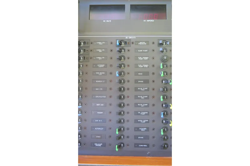 Slide: The Image of Electrical panel of a 2007 Hinckley Talaria 40 boat, showing various circuit switches. - 34