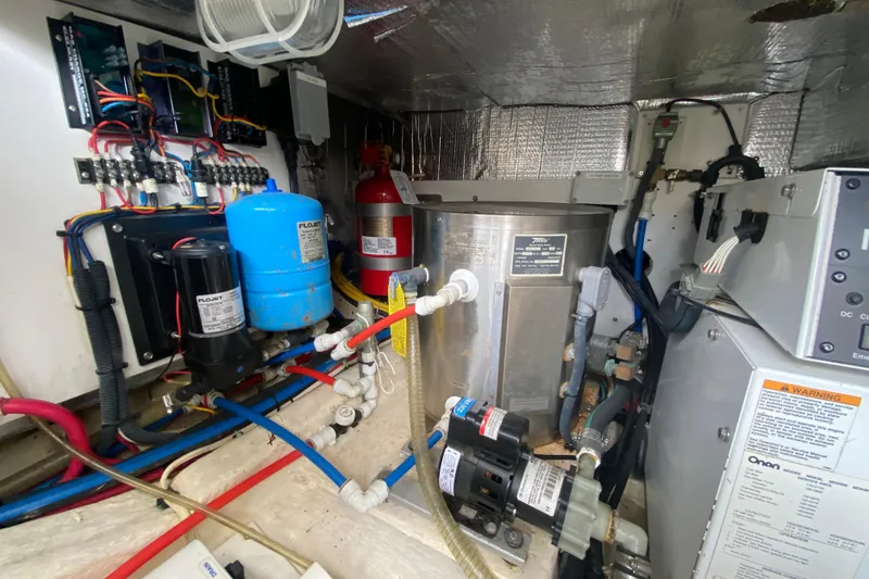 Slide: The Image of Engine room of a 2007 Hinckley Talaria 40, showcasing mechanical and electrical components. - 47