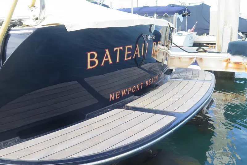 Slide: The Image of Hinckley Talaria 40 yacht, 2007 model, docked in Newport Beach, featuring elegant wooden deck. - 5