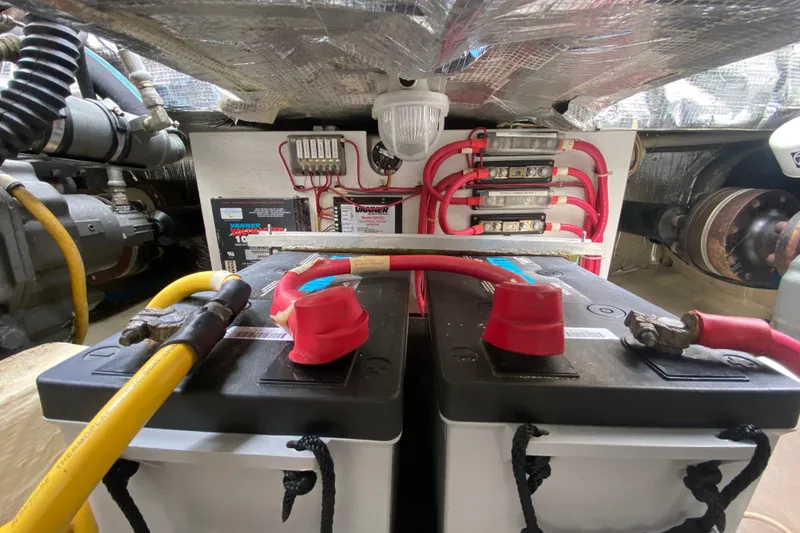 Slide: The Image of Engine compartment of a 2007 Hinckley Talaria 40, featuring batteries and wiring. - 54