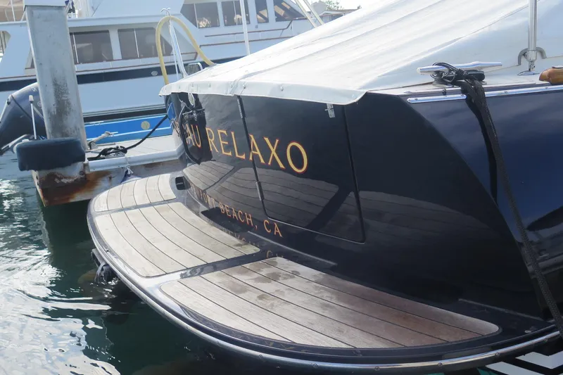 Slide: The Image of Hinckley Talaria 40 yacht, 2007 model, docked with wooden deck and sleek design. - 6