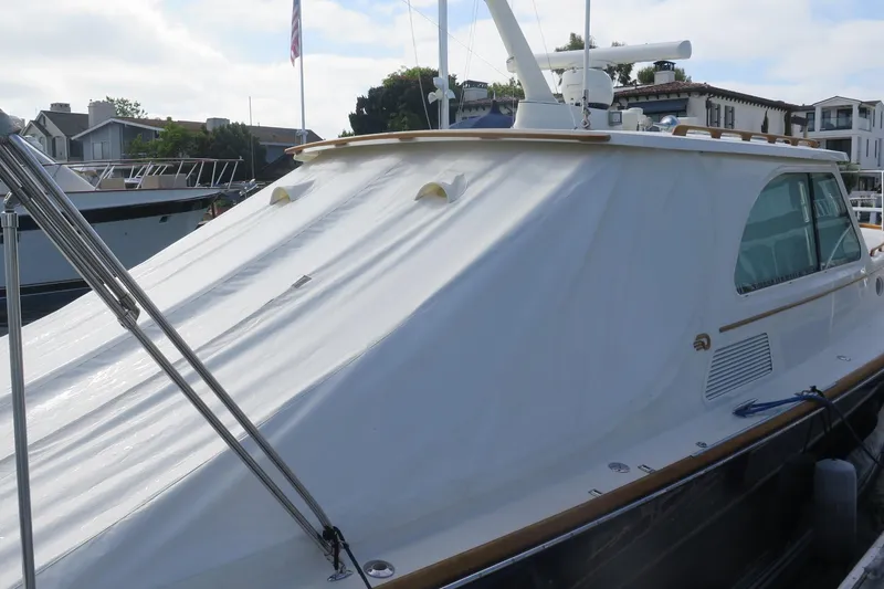 Slide: The Image of 2007 Hinckley Talaria 40 yacht docked, featuring sleek design and covered deck. - 7