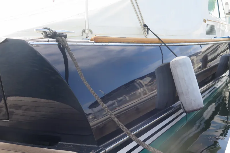 Slide: The Image of 2007 Hinckley Talaria 40 yacht side view with fender and dock reflections. - 9