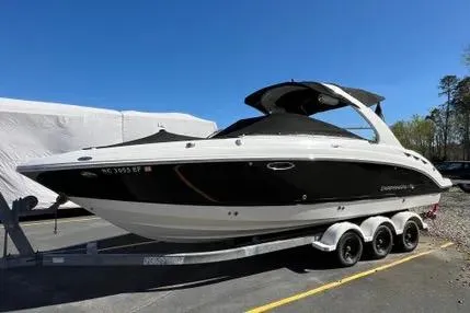 The Image of 2007 Chaparral 276 SSX boat on trailer, black and white design, parked outdoors. - 0