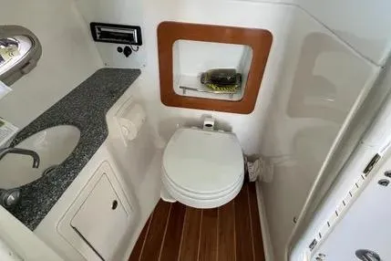 Slide: The Image of 2007 Chaparral 276 SSX boat bathroom with sink, toilet, and wooden flooring. - 3