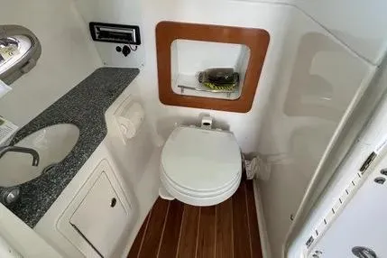 Slide: The Image of 2007 Chaparral 276 SSX boat bathroom with sink, toilet, and wooden flooring. - 5