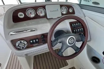 Slide: The Image of 2007 Chaparral 276 SSX boat dashboard with Garmin GPS and wood-trimmed steering wheel. - 7