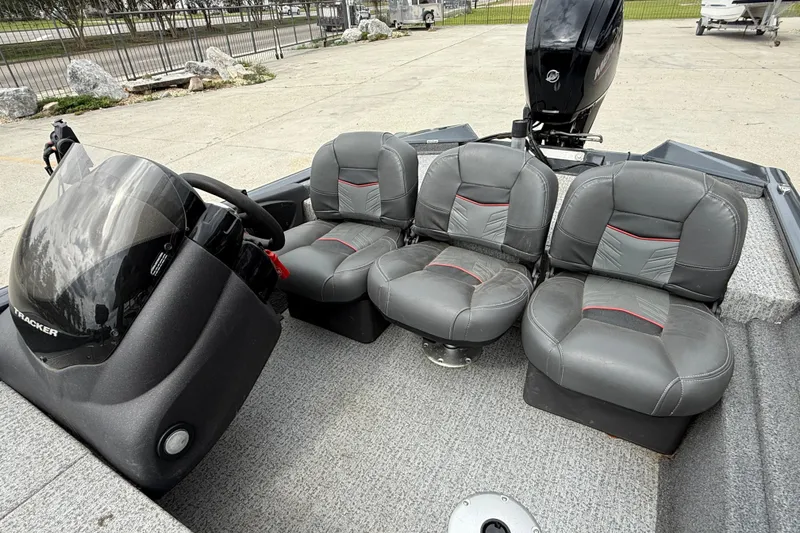 Slide: The Image of 2021 Tracker Pro Team 175 TF boat interior with gray seating and steering console. - 10