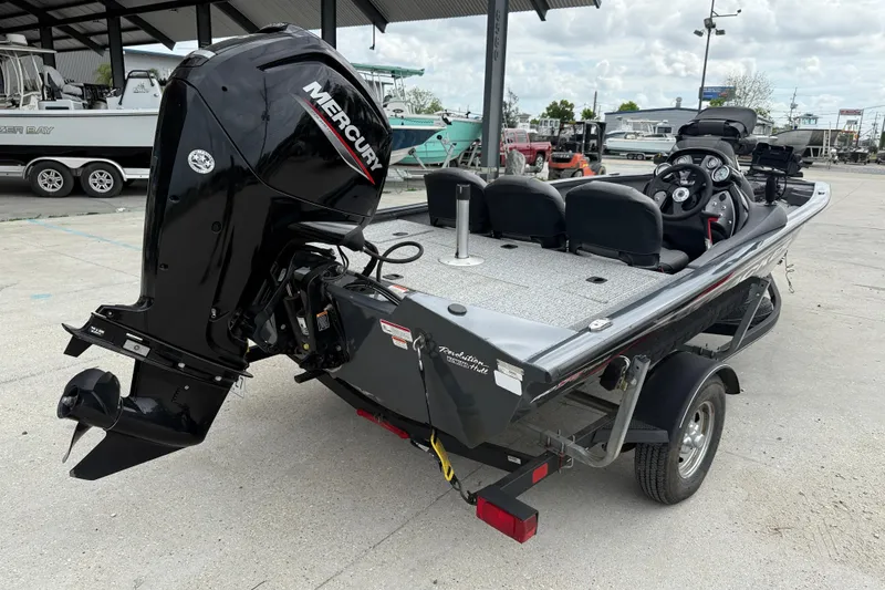 Slide: The Image of 2021 Tracker Pro Team 175 TF boat with Mercury engine, parked outdoors. - 6