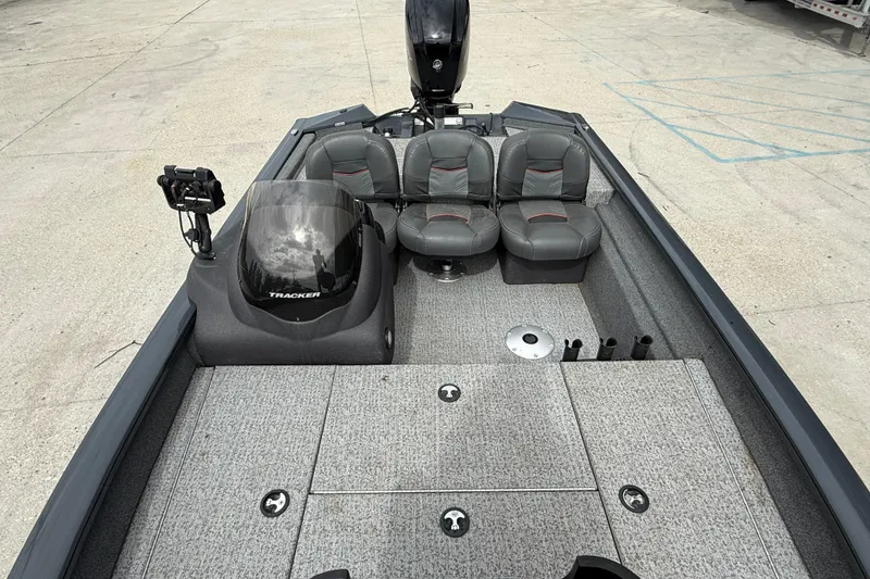 Slide: The Image of 2021 Tracker Pro Team 175 TF boat interior with seating and fishing rod holders. - 9