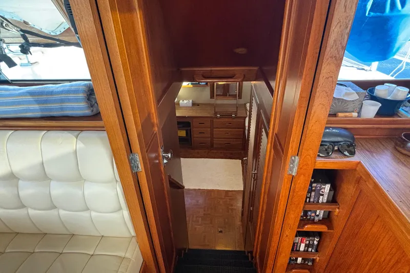 Slide: The Image of Interior view of 1989 Grand Banks 46 Classic yacht, featuring wooden cabinetry and seating. - 100