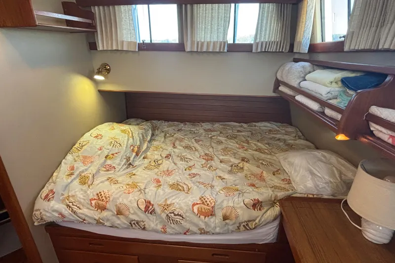 Slide: The Image of Cozy bedroom in 1989 Grand Banks 46 Classic yacht with seashell-themed bedding. - 102