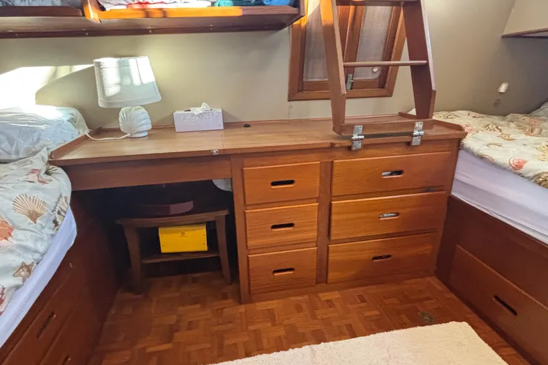 Slide: The Image of Interior of 1989 Grand Banks 46 Classic with wooden drawers and twin beds. - 105