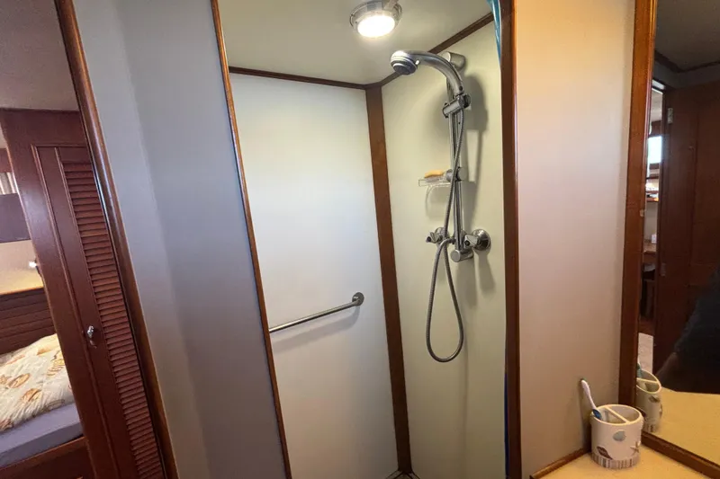 Slide: The Image of Shower area in 1989 Grand Banks 46 Classic yacht, featuring modern fixtures and wooden accents. - 108
