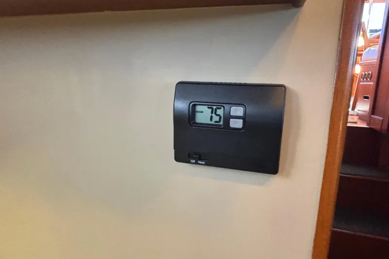 Slide: The Image of Thermostat set to 75°F inside 1989 Grand Banks 46 Classic yacht interior. - 112