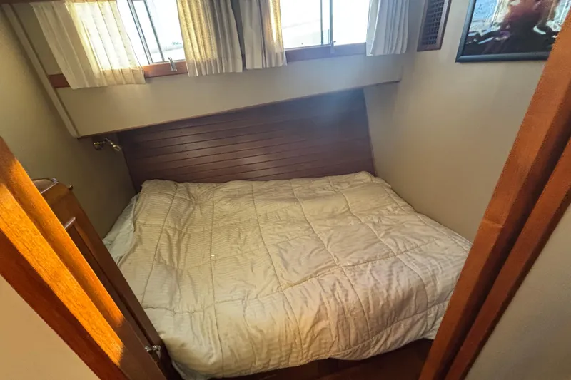 Slide: The Image of Cozy bedroom interior of 1989 Grand Banks 46 Classic yacht with wooden accents. - 118