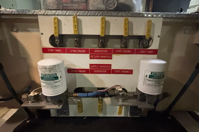Slide: The Image of Fuel system panel of 1989 Grand Banks 46 Classic boat with labeled valves and filters. - 137