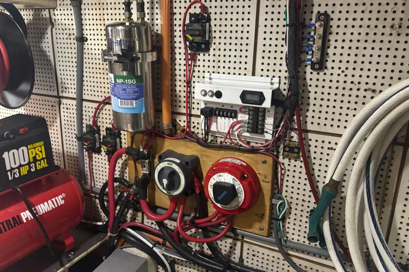 Slide: The Image of Electrical system setup in a 1989 Grand Banks 46 Classic boat engine room. - 140