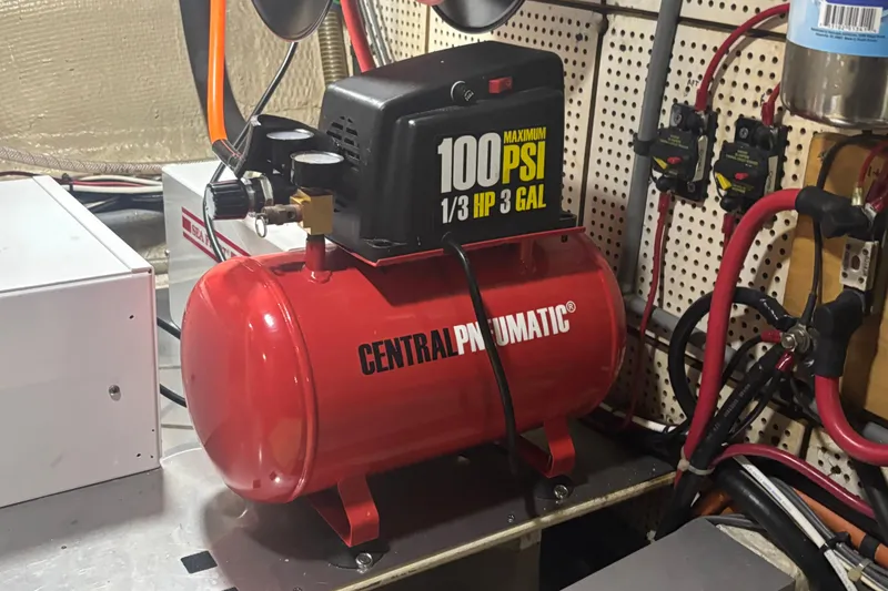 Slide: The Image of Red Central Pneumatic air compressor in a 1989 Grand Banks 46 Classic engine room. - 142