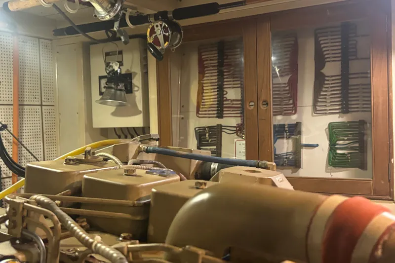 Slide: The Image of Engine room of 1989 Grand Banks 46 Classic yacht, showcasing mechanical components and wiring. - 145