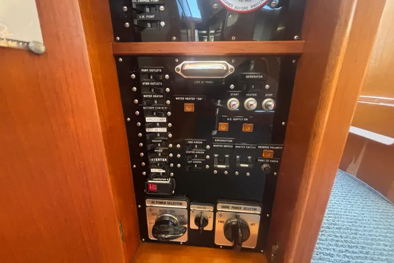 Slide: The Image of Control panel of a 1989 Grand Banks 46 Classic yacht, featuring various switches and dials. - 160