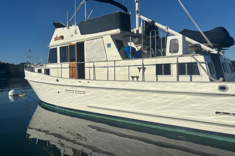 Slide: The Image of 1989 Grand Banks 46 Classic yacht on calm water, side view. - 21