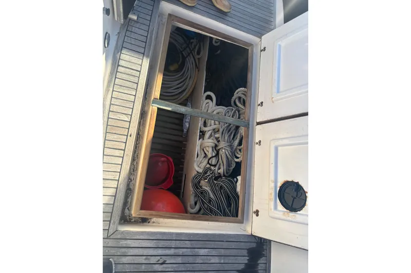 Slide: The Image of Storage compartment on 1989 Grand Banks 46 Classic boat, containing ropes and equipment. - 23