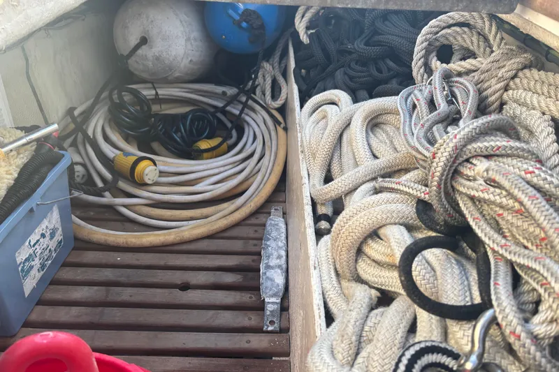 Slide: The Image of Storage area on a 1989 Grand Banks 46 Classic with ropes and cables neatly organized. - 24