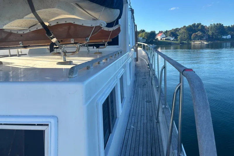 Slide: The Image of 1989 Grand Banks 46 Classic yacht deck with scenic waterfront view. - 25