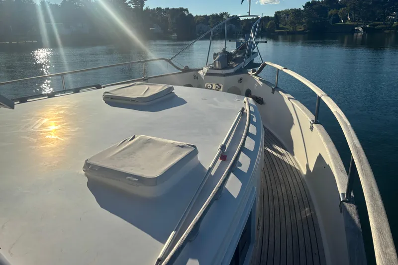 Slide: The Image of 1989 Grand Banks 46 Classic yacht deck with sunlit water view. - 29