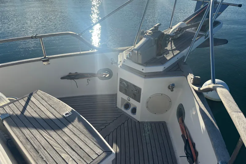 Slide: The Image of 1989 Grand Banks 46 Classic yacht deck with wooden finish and water reflection. - 30